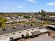 A beautiful aerial view of townhomes with a refreshing blue community pool surrounded by lush landscaping and palm trees at 418 E Woodman Dr, Tempe, AZ 85283