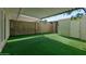 Backyard featuring green synthetic turf, storage shed, and covered patio perfect for entertaining at 418 E Woodman Dr, Tempe, AZ 85283