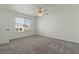 Bright bedroom with a ceiling fan and a view of the outdoors at 418 E Woodman Dr, Tempe, AZ 85283