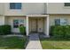 Cozy entrance to the townhome, featuring a tiled porch and manicured bushes at 418 E Woodman Dr, Tempe, AZ 85283