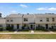 Inviting exterior view of townhomes with manicured lawns and quaint entrances at 418 E Woodman Dr, Tempe, AZ 85283