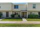 Charming entrance to townhome, featuring a covered porch and manicured bushes at 418 E Woodman Dr, Tempe, AZ 85283