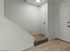 Hallway with stairs, neutral walls, wood flooring, and two entry doors with modern hardware at 418 E Woodman Dr, Tempe, AZ 85283