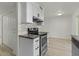 Updated kitchen with modern appliances and white cabinets at 418 E Woodman Dr, Tempe, AZ 85283