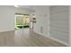 Bright living room with sliding glass doors to the backyard, built-in shelving, and wood floors at 418 E Woodman Dr, Tempe, AZ 85283