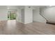 Open living room featuring built-in shelving, wood flooring, and staircase access to the upper level at 418 E Woodman Dr, Tempe, AZ 85283