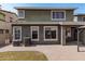 Exterior view of home with covered patio, brick-paved area, and mature landscaping at 4337 E Vaughn Ave, Gilbert, AZ 85234