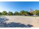 Community basketball court with mature trees, benches, and parking at 4337 E Vaughn Ave, Gilbert, AZ 85234