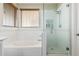 Bathroom with bathtub, walk-in shower, and neutral tile at 4337 E Vaughn Ave, Gilbert, AZ 85234