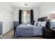 Well-lit bedroom with carpet, featuring a comfortable bed, closet, and dark curtains for room darkening at 4337 E Vaughn Ave, Gilbert, AZ 85234