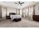 Spacious bedroom with neutral carpet, windows with natural light, and a king-size bed at 4337 E Vaughn Ave, Gilbert, AZ 85234
