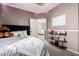 Neutral bedroom with a cozy vibe, a plush bed, open doorway, and a functional shelving unit at 4337 E Vaughn Ave, Gilbert, AZ 85234