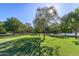 Scenic view of community common area with lush greenery, mature trees, and walking paths at 4337 E Vaughn Ave, Gilbert, AZ 85234