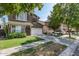 Two-story home featuring green exterior, red shutters, a well-kept lawn and long driveway at 4337 E Vaughn Ave, Gilbert, AZ 85234