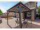 Outdoor gazebo with seating, brick-paved area, and mature landscaping at 4337 E Vaughn Ave, Gilbert, AZ 85234