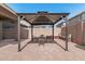 Outdoor gazebo with seating, brick-paved area, and mature landscaping at 4337 E Vaughn Ave, Gilbert, AZ 85234