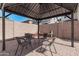 Outdoor gazebo with seating, brick-paved area, and mature landscaping at 4337 E Vaughn Ave, Gilbert, AZ 85234