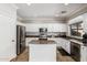Spacious kitchen with stainless steel appliances, granite counters, central island, and ample cabinetry at 4337 E Vaughn Ave, Gilbert, AZ 85234