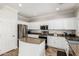 Bright kitchen featuring granite counters, white cabinets, and stainless steel appliances at 4337 E Vaughn Ave, Gilbert, AZ 85234