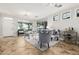 Bright living room with travertine tile flooring, large windows, elegant furniture, and a crystal chandelier at 4337 E Vaughn Ave, Gilbert, AZ 85234