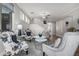 Elegant living room featuring travertine tile flooring, modern furnishings, crystal ceiling fans and a staircase at 4337 E Vaughn Ave, Gilbert, AZ 85234
