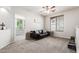 The living room features a couch, a window, and neutral carpet at 4337 E Vaughn Ave, Gilbert, AZ 85234