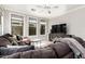Cozy living room with plush seating, entertainment center, and ample natural light from windows at 4337 E Vaughn Ave, Gilbert, AZ 85234