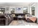 Comfortable living room featuring a large sectional sofa, multiple windows, and modern décor at 4337 E Vaughn Ave, Gilbert, AZ 85234