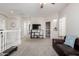 Spacious loft with neutral carpet, dark sofa and television at 4337 E Vaughn Ave, Gilbert, AZ 85234