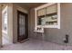 Covered front patio with brick flooring, security door, and space for outdoor plants at 4337 E Vaughn Ave, Gilbert, AZ 85234
