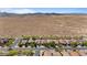 Expansive aerial view showcasing a neighborhood with uniform homes against a backdrop of rolling desert hills at 4617 W Cottontail Rd, Phoenix, AZ 85086