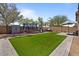 Expansive backyard featuring artificial turf, a trampoline, and other outdoor play equipment at 4617 W Cottontail Rd, Phoenix, AZ 85086