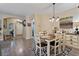 Bright dining room with wood-look floors and seating for six, perfect for Gathering gatherings at 4617 W Cottontail Rd, Phoenix, AZ 85086