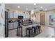 Well-appointed kitchen boasts gray cabinets, granite countertops, stainless appliances, and a central island with bar seating at 4617 W Cottontail Rd, Phoenix, AZ 85086