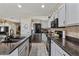 Kitchen featuring a granite island, stainless steel appliances, and updated cabinetry at 4617 W Cottontail Rd, Phoenix, AZ 85086