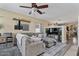 Comfortable living room features a ceiling fan, a large gray couch, and hardwood floors at 4617 W Cottontail Rd, Phoenix, AZ 85086