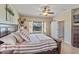 The main bedroom features a king bed, neutral decor, and views of the backyard at 4617 W Cottontail Rd, Phoenix, AZ 85086