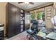 Office with custom cabinets, ceiling fan, and natural light from dual windows at 4617 W Cottontail Rd, Phoenix, AZ 85086