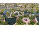Aerial view of neighborhood park with winding lake, playground, splash pad, and picnic areas amidst lush green trees at 4617 W Cottontail Rd, Phoenix, AZ 85086