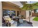 Comfortable outdoor seating area on the patio, shaded by a large umbrella with a turf yard view at 4617 W Cottontail Rd, Phoenix, AZ 85086
