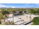 Aerial view of skate park with ramps and rails surrounded by green space with residential buildings in the distance at 4617 W Cottontail Rd, Phoenix, AZ 85086