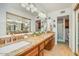 Bathroom features double sinks, granite counters, and a decorative mirror at 4618 E Valley View Dr, Phoenix, AZ 85044