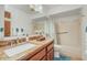 Bathroom featuring a granite countertop, wood cabinets, and a tub with shower at 4618 E Valley View Dr, Phoenix, AZ 85044