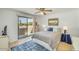 Bedroom with sliding glass doors to balcony, ceiling fan, and neutral decor at 4618 E Valley View Dr, Phoenix, AZ 85044