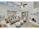 Cozy living room featuring a fireplace, plush sofa, and ample natural light at 4618 E Valley View Dr, Phoenix, AZ 85044