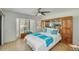 Bright main bedroom boasts a large window, ceiling fan, and built in storage at 4618 E Valley View Dr, Phoenix, AZ 85044