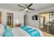Comfortable main bedroom featuring a ceiling fan, sliding glass doors to the patio, and a television at 4618 E Valley View Dr, Phoenix, AZ 85044