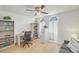 Bright office with built-in shelving, arched windows, and a ceiling fan at 4618 E Valley View Dr, Phoenix, AZ 85044