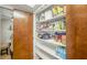 Well-stocked pantry with lots of shelving located off of dining area at 4618 E Valley View Dr, Phoenix, AZ 85044