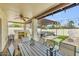 Outdoor patio with a ceiling fan, built-in grill, and a dining table surrounded by well manicured grass at 4618 E Valley View Dr, Phoenix, AZ 85044